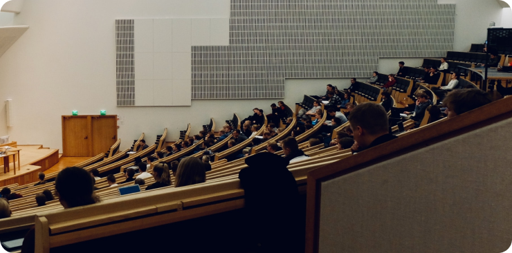 A large lecture theatre of people watching a speaker.
