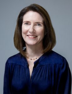 A portrait photo of Jessica Turner, Chief Executive Officer at QS, smiling and looking at the camera.