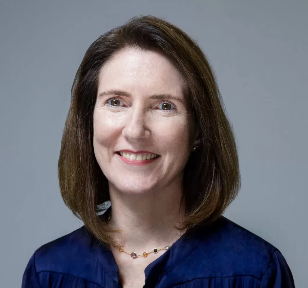 A portrait photo of Jessica Turner, Chief Executive Officer at QS, smiling and looking at the camera.