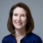 A portrait photo of Jessica Turner, Chief Executive Officer at QS, smiling and looking at the camera.