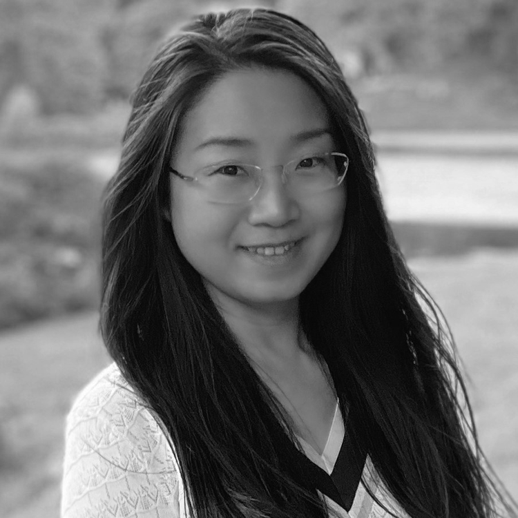 A black and white portrait of Alice Wei, Senior Consultant at QS, smiling with glasses and long dark hair.