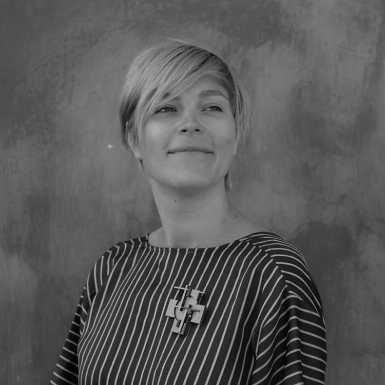 A black and white portrait of Dara Bukhtoyarova, Consulting Projects Coordinator at QS, looking away into the distance and wearing a striped top.