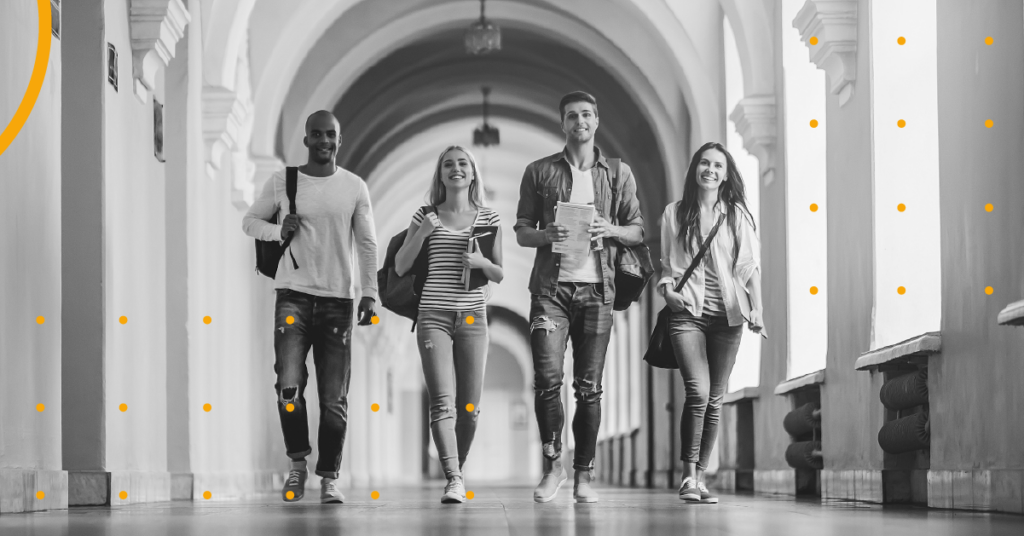 Four students walking on a university campus