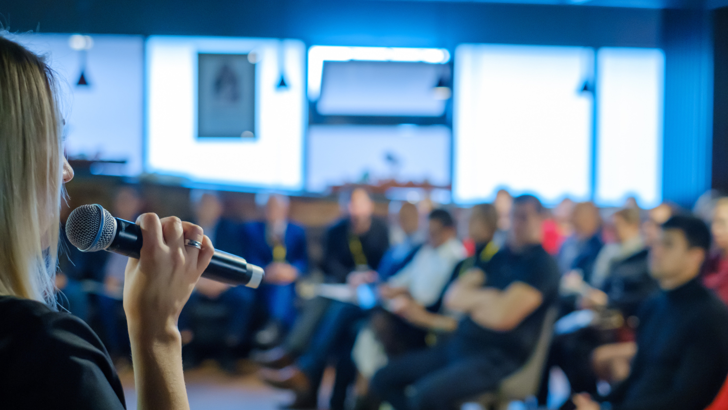 A woman presenting at an event.